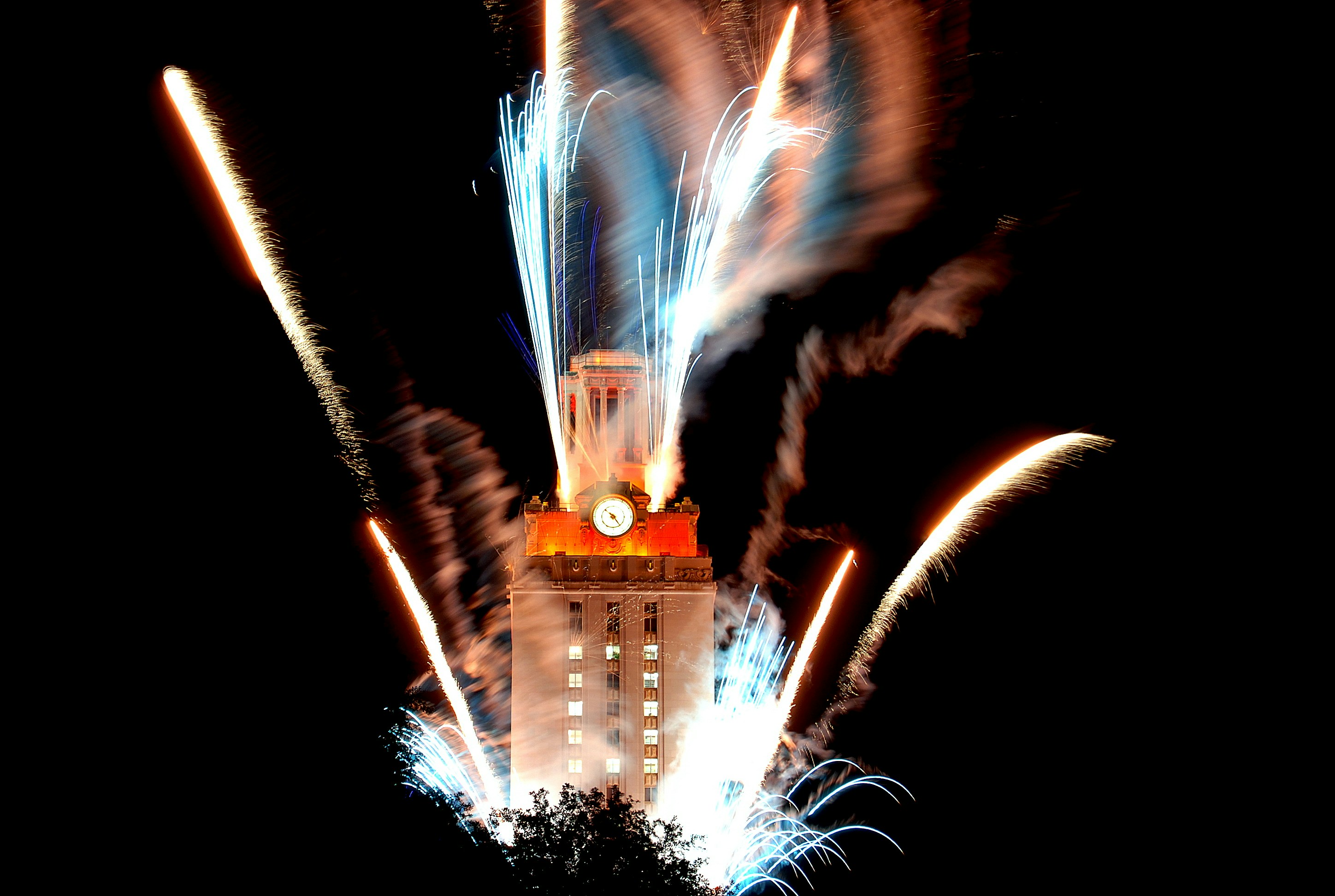 The UT Austin Tower lit up with fireworks